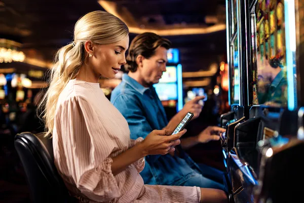 CD33 App — Fast, responsive, and optimized for all devices A cheerful woman in traditional clothing using her smartphone during a festive moment, showing how easily the CD33 app fits into everyday life.