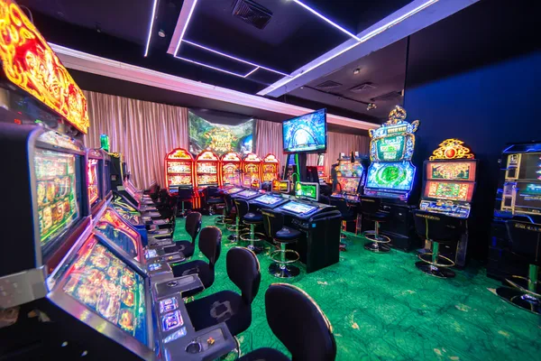 A man celebrating a winning moment on his laptop while gaming symbols float around him, capturing the excitement of CD33 games.