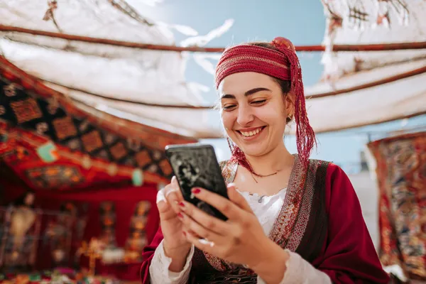 A player using their smartphone during a festive local event, representing CD33’s fully mobile-friendly casino.
